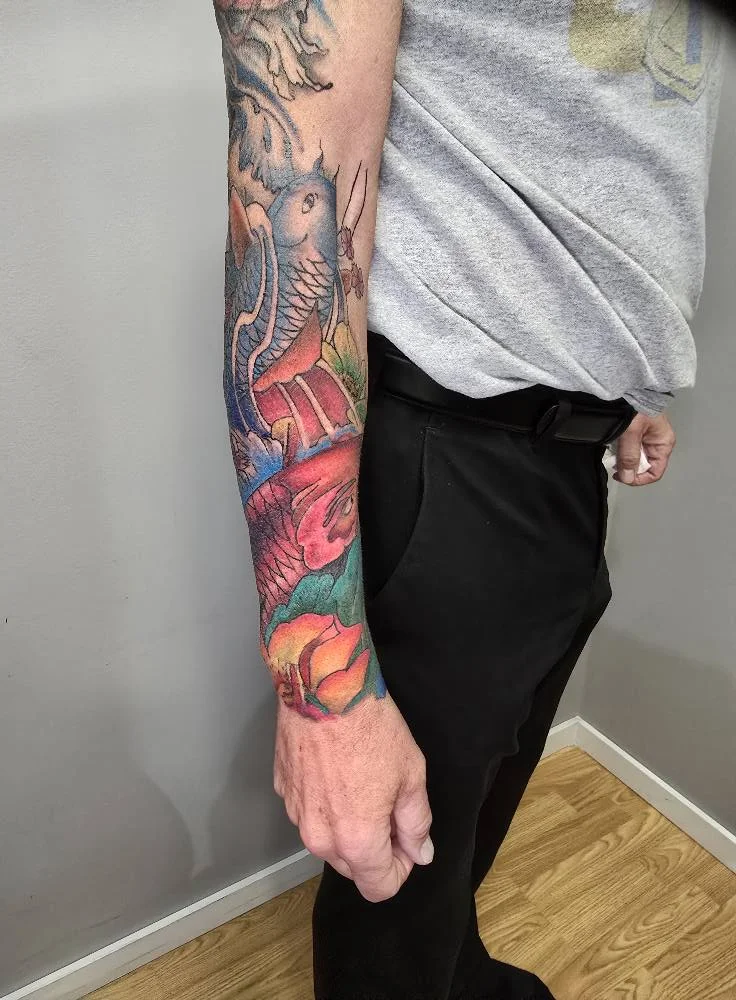 Custom colorful rose and floral sleeve tattoo - Mike Kuntz Moose Jaw SK