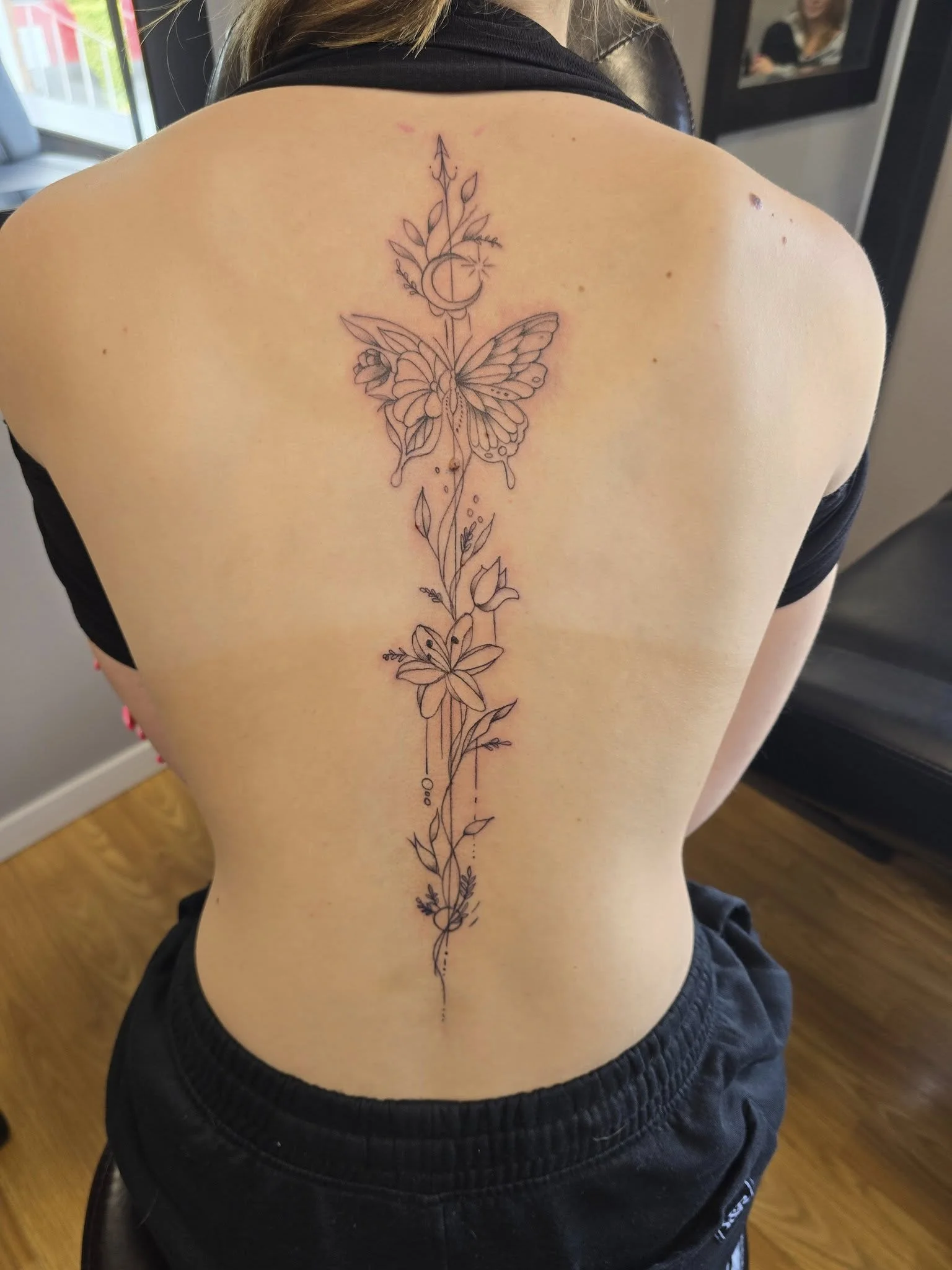 Floral spine tattoo for women - Elegant blackwork spine tattoo Moose Jaw
